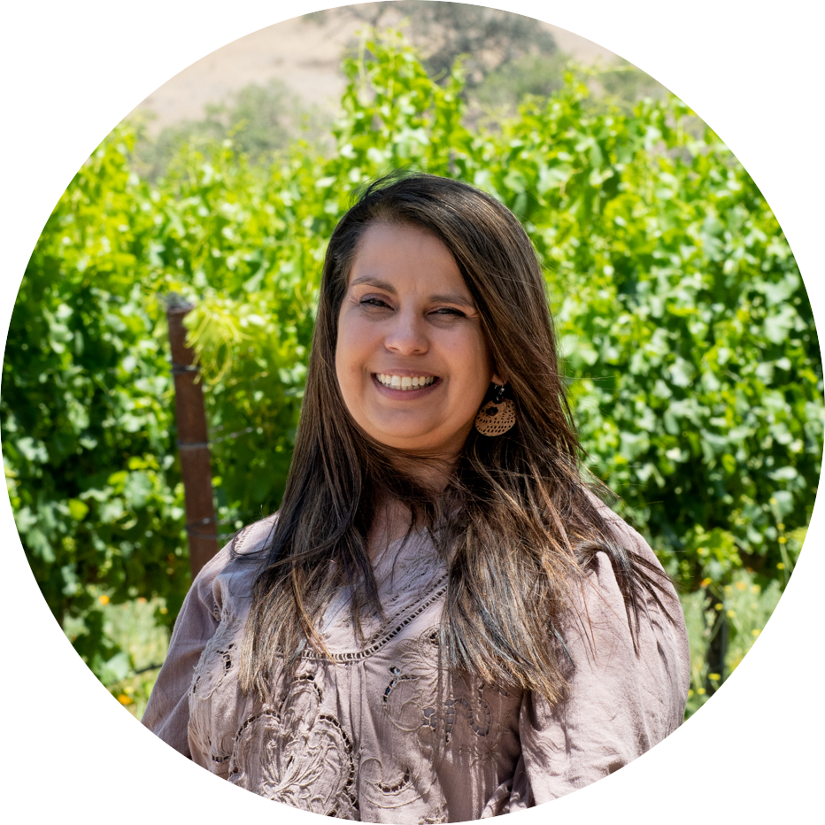 Awilda in front of green vines